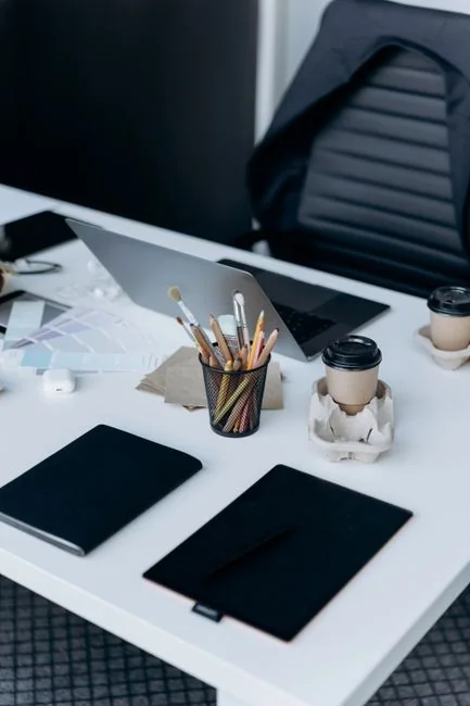 A modern workspace with a smartphone displaying a screen and a computer setup, ideal for business and technology themes.